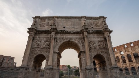 roma , Italy - 08 15 2021: hyperlapse of Arch of Constantine with Colosseum in the back . Amazing architecture details of Arco di Constantino in the city of Rome, Italy. Colosseo, Roma - vertigo effec