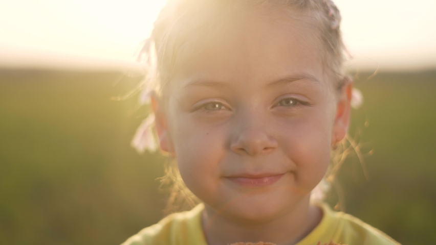 Happy little girl in park at sunset. Kid with toy teddy bear looks into camera. Girl smiles. Happy girl with friend teddy bear. Kid play with toy in park. Girl with friend in park at sunset.Baby smile Royalty-Free Stock Footage #1077698456