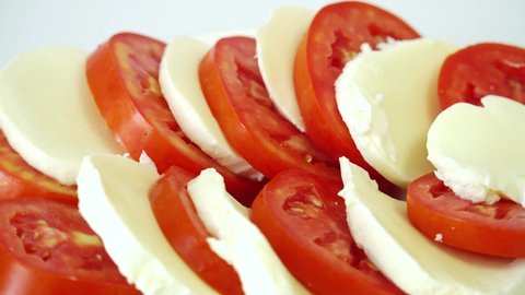 Italian tomato and mozzarella caprese salad rotate on their axis