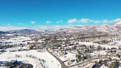 Large Townscape With Mountain Ranges On Background At Steamboat Ski Resort In Steamboat Springs, Colorado. - Aerial Drone Shot