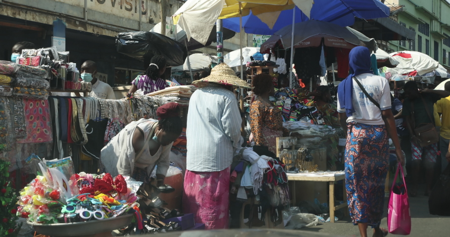 ACCRA, GHANA - 20 DEC 2020: Accra Ghana very busy market street from inside car. Historical busy congested market area downtown, Accra, Ghana. Historic place to buy and sell products. | Shutterstock HD Video #1077708167