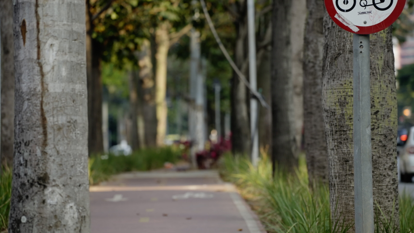 Bicycles riding in the bike lane in a busy street of a big city. Footage shot in 4K high definition in Faria Lima Downtown in Sao Paulo, Brazil.