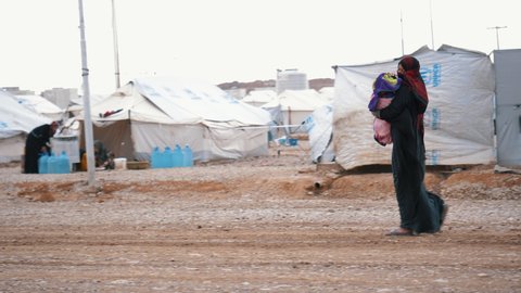 Slow Motion of Muslim mother walking in a refugee camp. November 9, 2017, Mosul, Iraq.