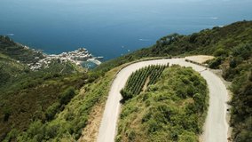 Motorcyclist drives through beautiful Italian landscape in summer