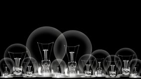Light bulbs going from dark to light with Collaboration, Teamwork, Motivation, Vision and Goal fiber text on black background. High quality 4k video.