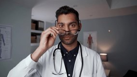 Mixed race male doctor standing in office wearing stethoscope 