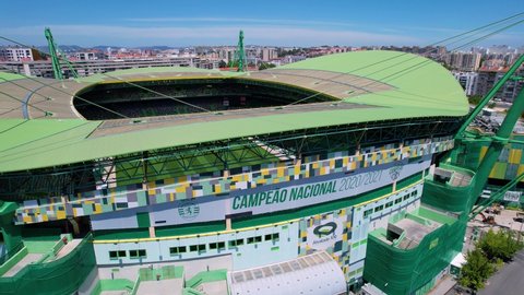 Lisbon , Portugal - 08 17 2021: Aerial view of detail on the entrance side of the Jose Alvalade stadium, in Lisbon - circling, drone shot	