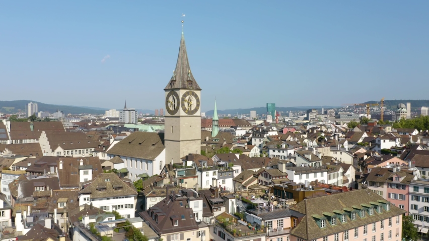 Cinematic Aerial Shot of Church of St. Peter in Zurich, Switzerland on Beautiful Summer Day. This Historic Church has the Largest Clock Face in Europe
