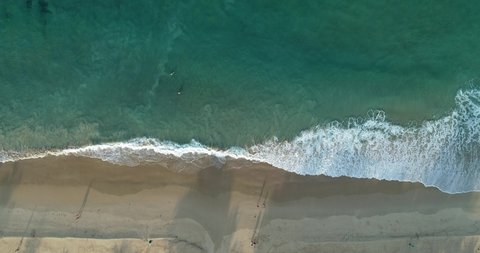 Aerial view of sea and sand beach at sunset or sunrise Amazing Wave crashing on sandy shore Pink sand beach Beautiful for holiday summer background Tropical destination High quality footage from drone