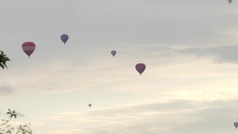 Bristol, England- August 14, 2021: Balloons fly over Bristol at sunset