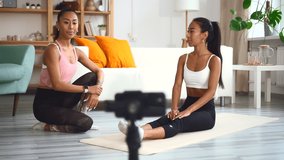 Coach help woman practice yoga exercise, show lean side bend for smartphone recording video