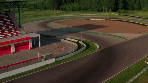 Kart racing or karting training. Professional kart, go-kart moving on race track. Aerial view of auto circuit