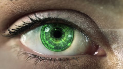 Macro shot of young female green eye with hi tech futuristic technology hud application with augmented reality holograms. Internet of things, surveillance system.