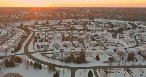 Aerial view of landscape top of the winter town residential houses with snow on covered houses and roads.