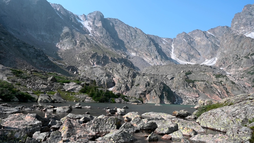 A hiker makes his way across the drainage at Sky Pond, a popular hiking destination in Rocky Mountain National Park, Colorado, USA.