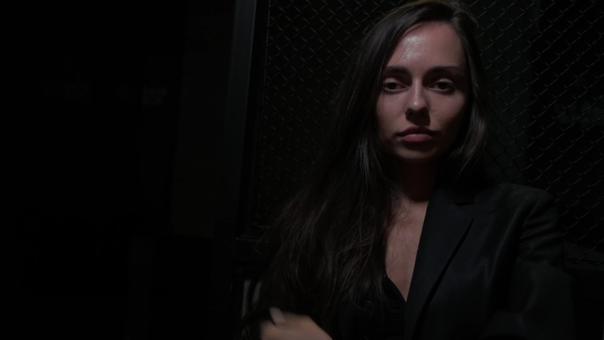 sexy brunette in black on a dark background