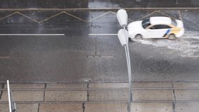 Flooded cars in the city during heavy rain. Big puddle on a road. Video 4k resolution