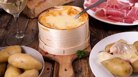 mont d'or- traditional French cheese fondue with ham and potato	