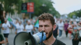 Angry political protester guy with bullhorn marches in protest crowd. Male rebel speaking on demonstration revolt resistance. Strike activist demonstrator man on opposition rally riot with megaphone. - Powered by Shutterstock - Get 15% off with code: PIKWIZARD15