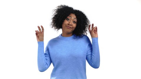 Mixed race woman showing with hands and two fingers air quotes gesture, bend fingers isolated over white background. Not funny, irony and sarcasm concept.
