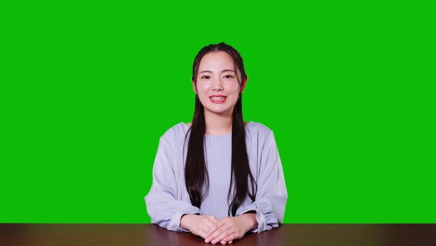 Young asian woman taking video calling. Green background for chroma key composition. Royalty-Free Stock Footage #1077783482