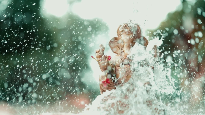 Water splash on lord ganesha sculpture. celebrate lord ganesha festival.  Royalty-Free Stock Footage #1077787163