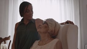 Storytelling video of a grandmother and her granddaughter spending time together at home. Lifestyle concept about third age and family 