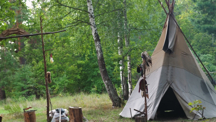 Forest home of the Indians. Wigwam indian teepee. The life of nomadic tribes. The wigwam stands in the forest. A hut of nomadic peoples. A home of Indians. tippi aka in the forest.