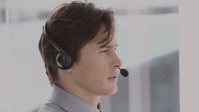 Animation of moving lines over man wearing phone headset. global business, digital interface and technology concept digitally generated video.