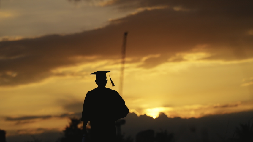 Graduation Congratulations on the day of graduation at the university, Sunset Silhouette orange sky Slow motion 4K Royalty-Free Stock Footage #1077793022