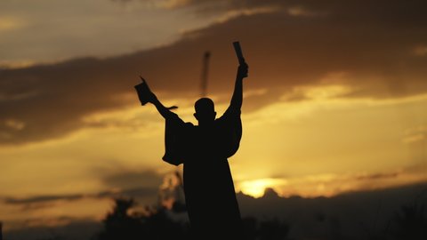 Graduation Congratulations on the day of graduation at the university, Sunset Silhouette orange sky Slow motion 4K