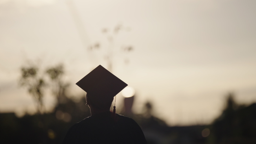 Graduation Congratulations on the day of graduation at the university,Sunset Silhouette orange sky Slow motion 4K | Shutterstock HD Video #1077793034