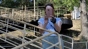 A young woman takes a video about nature on a smartphone. In the summer in the pine forest. Sports and recreation. Lifestyle.