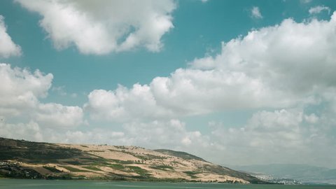 Breeze clouds running over the Galilee sea, Kinneret and Jordan river, with mountains and Tiberias on background, Israel, Middle east