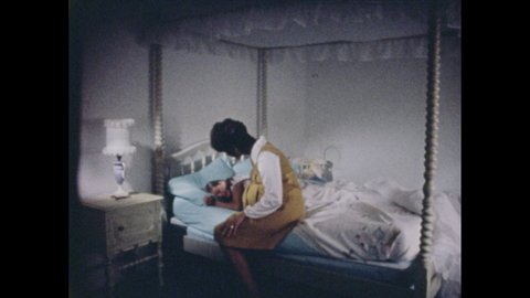 1970s: Woman sits on the edge of the girl's bed. Man comes in with a suitcase. Older woman sits on the other side of the bed. Girl and younger woman hug. Girl smiles. Girl and older woman read a book.