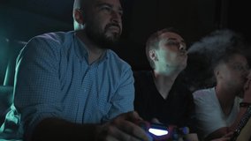 a bearded guy plays with friends in a game console
