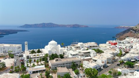 Santorini, Greece: Aerial view of Fira, capital city of Santorini (Thira) island, Candlemas Holy Orthodox Metropolitan Cathedral, caldera cliffs above sea - landscape panorama of Europe from above