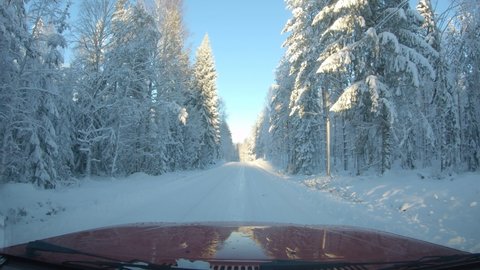 Windscreen view driving through a beautiful snowy winter wonderland