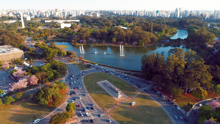 Metropolis aerial landscape of city of Sao Paulo, Brazil. Landmark avenue and buildings of city. Independence square. Independence monument. Ibirapuera park. Ibirapuera lake. Sao Paulo, Brazil. Royalty-Free Stock Footage #1077813869