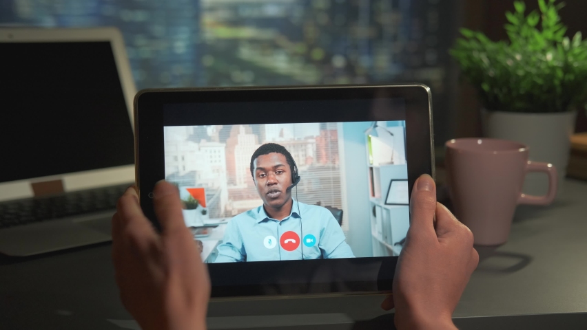 Video calling to the call center on tablet. Horizontal screen. Woman holding tablet.