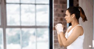 Animation of woman boxing against modern gym interiors. sports and competition concept digitally generated video.