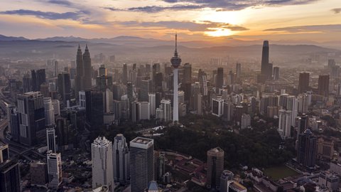 KUALA LUMPUR, MALAYSIA - NOVEMBER 8, 2020 : Time lapse: Sunrise Kuala Lumpur city view overlooking the KL city skyline  at dawn with busy city streets in Malaysia. 