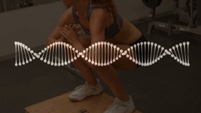 Animation of dna strand over strong woman exercising in gym. global sports, fitness and data processing concept digitally generated video.