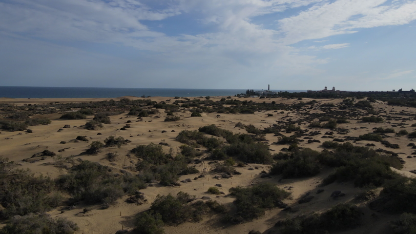 Low altitude drone flight over a sandy beach. Amazing view of the Gran Canaria island Maspalomas in Spain. | Shutterstock HD Video #1077830948