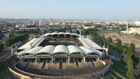 Lyon, France - July 2021 : Gerland stadium in rugby configuration, drone aerial view with Notre Dame de Fourviere Basilica and Part-Dieu skyscrapers in back