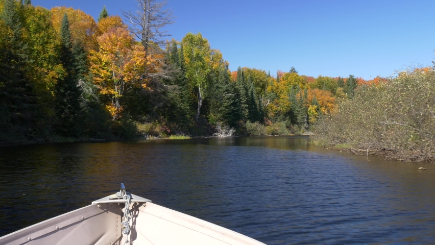 Boat drive on river and fall colors in Algonquin Provincial Park, Ontario, Canada