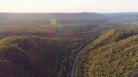 Aerial video of mountains, road and summer forest