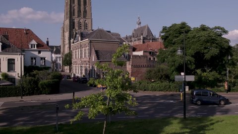 Zutphen , Gelderland , Netherlands - 08 08 2021: Street view of medieval tower town rising to reveal the city center around central church