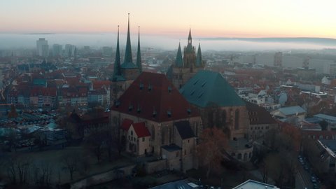Aerial Upward Shot Of St. Severus Amidst Residential Structures Against Sky During Winter - Erfurt, Germany