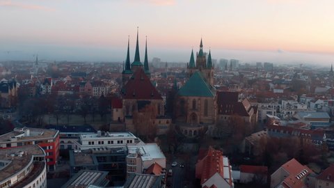 Aerial Panning Shot Of St. Severus Church Amidst Houses In Old Town During Sunrise - Erfurt, Germany